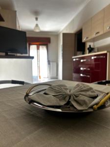 a plate with a bow on top of a table at B&b La Casa di Michela in Castelmezzano