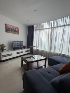 a living room with a couch and a coffee table at VORTEX SUITES KLCC By SKYLINE in Kuala Lumpur