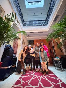 a group of people posing for a picture in a lobby at Dar Souran in Tangier