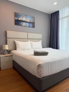 a bedroom with a large bed with a white bedspread at VORTEX SUITES KLCC By SKYLINE in Kuala Lumpur