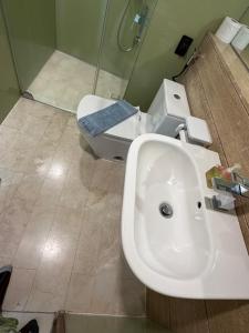 a bathroom with a sink and a toilet at VORTEX SUITES KLCC By SKYLINE in Kuala Lumpur +26 photos