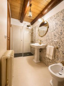 a bathroom with a sink and a toilet and a mirror at Casa de Aira Padron 