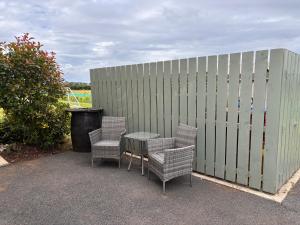 a patio with chairs and a table and a fence at Room with a View in Aldergrove