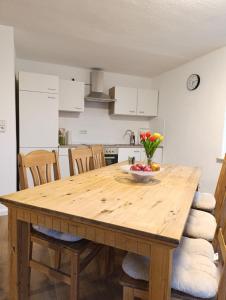 a kitchen with a wooden table with a bowl of fruit on it at Landhaus Leopold in Sanitz