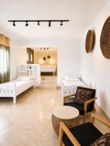 a living room with two beds and a table at Casa Boha Garden in Dhërmi