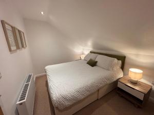 a small bedroom with a bed and a night stand at Room with a View in Aldergrove