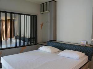 a bedroom with a bed with two pillows on it at Fancy Resort in Ban Samran
