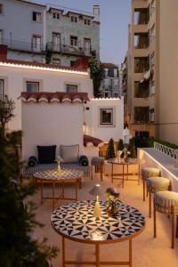 a patio with tables and chairs and buildings at Villa Dorothea in Lisbon