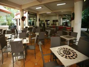 an empty restaurant with tables and chairs in a room at Splash Oasis Resort & Hotel in Forestry