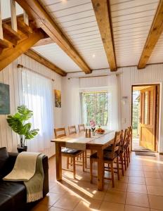 a dining room with a table and chairs at Holiday Homes Eliza in Druskininkai