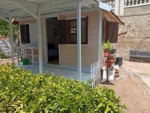 a house with a porch with a plant on it at Castel bungalow in Palafolls +1 photo