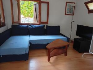 a room with a couch and a table and a television at Castel bungalow in Palafolls