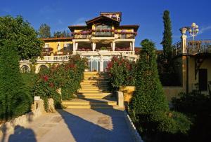 a large house with stairs leading up to it at Villa Althea in Mango