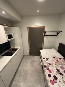 a small kitchen with a bed in a room at Hotell Vänersborg in Vänersborg