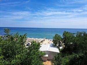 a view of a beach with umbrellas and the ocean at Beach House Cabacum in Golden Sands