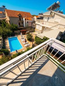 a staircase leading up to a house with a swimming pool at VODICE KRAJE APARTMENTS in Vodice