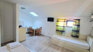 a small room with a bed and a table in it at Titulescu Apartments in Bucharest