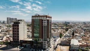 a tall building with a crane on top of it at Wlat Hotel in Erbil