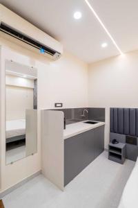 a kitchen with a sink and a bunk bed at Lake Bloom Residency in Mumbai