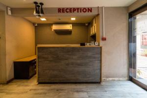 a reception area of a restaurant with a sign on the wall at Lake Bloom Residency in Mumbai