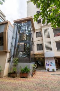 a building with a glass facade with potted plants at Lake Bloom Residency in Mumbai