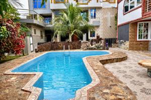 a swimming pool in the backyard of a building at Immanuel Victory Hotel & Restaurant in Ajenkotoku