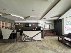 a living room with a couch and a table at Hotel Corbett Inn in Rudrapur
