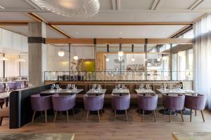 a dining room with tables and purple chairs at Park James in Menlo Park