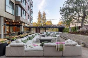 a courtyard with couches and tables and a building at Park James in Menlo Park