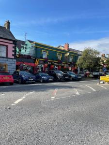 a street with cars parked in front of a building at 7 Main st in Camlough