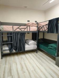 a room with two bunk beds and a wooden floor at БорБор in Osh