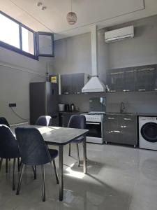 a kitchen with a table and chairs in it at БорБор in Osh
