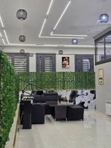 a living room with black furniture and a green wall at БорБор in Osh