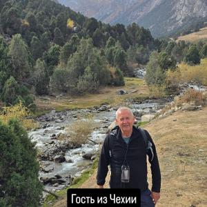 an older man standing in front of a river at БорБор in Osh