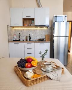 a tray of fruit on a table in a kitchen at Студия у чистейшего Моря! in Gonio