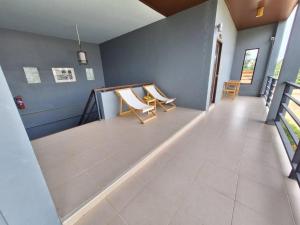 a hallway with two chairs in a house at Lantanoblesse in Ko Lanta
