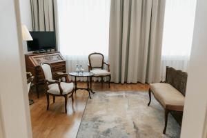 a living room with a table and chairs and a television at Hotel Pod Zeleným Dubem in Bohumín