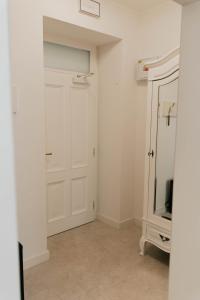 a white room with a door and a tv at Hotel Pod Zeleným Dubem in Bohumín