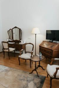a living room with a tv and a table and chairs at Hotel Pod Zeleným Dubem in Bohumín +59 photos