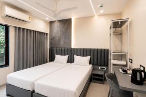 a hotel room with a bed and a desk and a desk at Lake Bloom Residency in Mumbai +26 photos