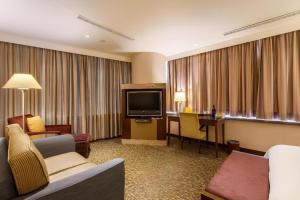 a hotel room with a couch and a television at Hotel HD Palace in Taipei