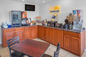 a restaurant with a counter with a table and a tableablish at Days Inn by Wyndham Eureka CA in Eureka