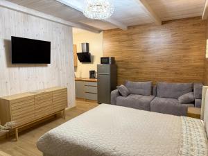 a living room with a bed and a couch at Bukovets' in Yaremche