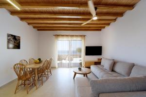 a living room with a couch and a table at Giourgas Studios & Apartments in Provatas