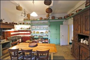 a kitchen with a wooden table and chairs at Maison Emile Teissier in Vébron +57 photos