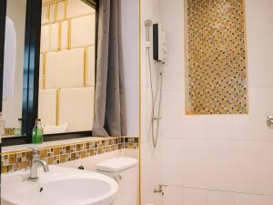 a bathroom with a sink and a shower at Debua Mahasarakham in Maha Sarakham
