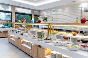 a buffet line with plates and bowls of food at Tripolis Hotel in Pamukkale