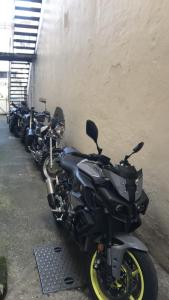 a row of motorcycles parked next to a wall at A Maiden Rest in Weymouth