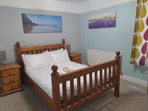 a bedroom with a bed with a dog laying on it at A Maiden Rest in Weymouth +22 photos