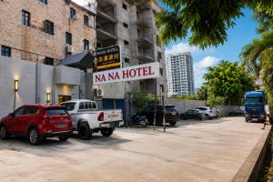 a hotel with a truck parked in a parking lot at Hotel Nana in Abidjan